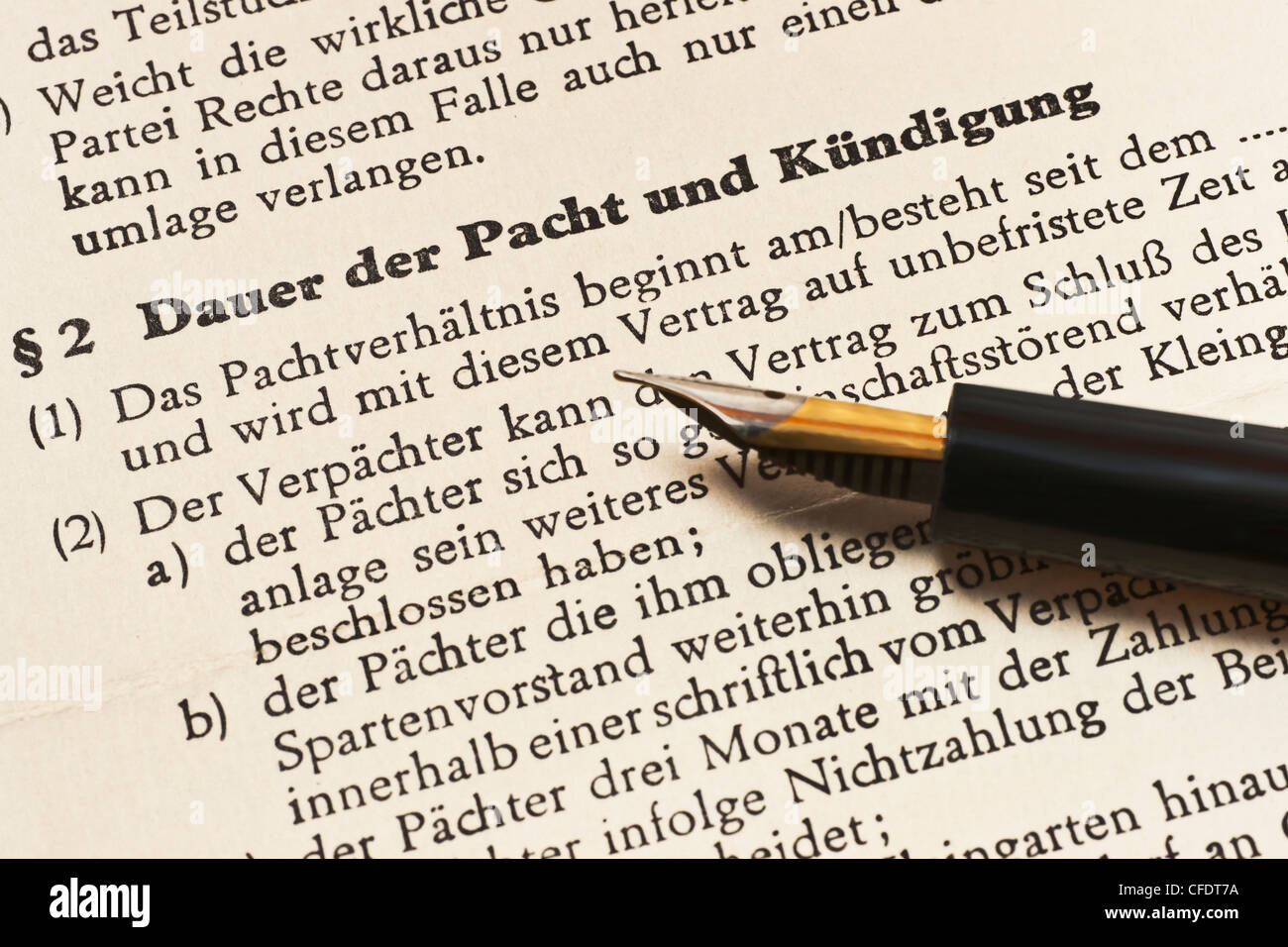 old lease contract from 1968, German language, duration of the lease and cancellation, alongside is a fountain pen. Stock Photo