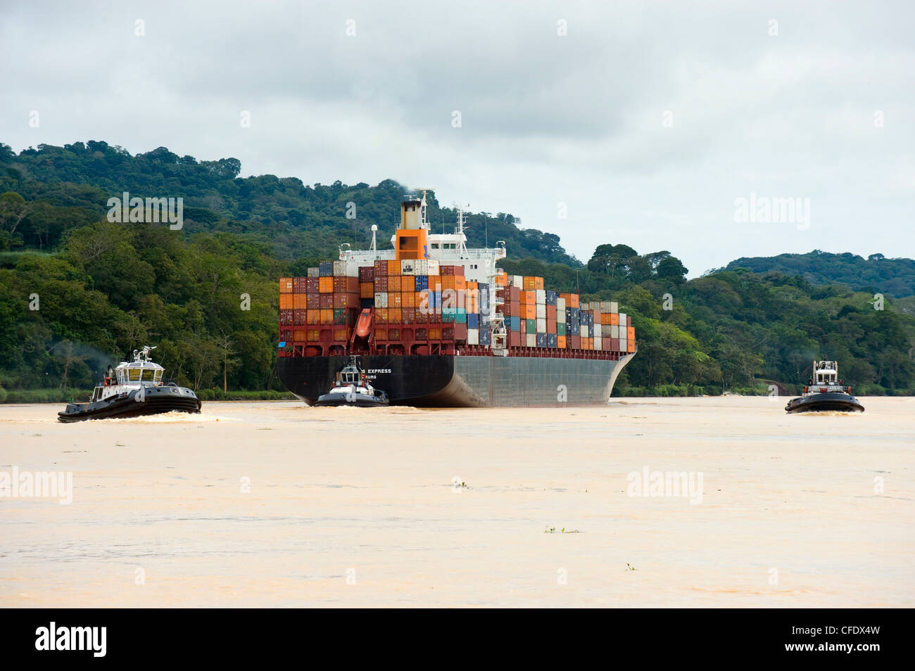 Tug boat and container ship on the Panama Canal, Panama City, Panama, Central America Stock Photo