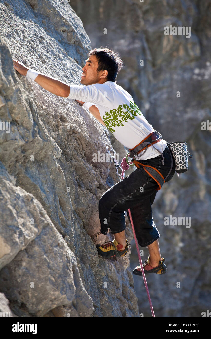 A male rockclimber climbing at Echo Canyon, Canmore, Alberta, Canada Stock Photo