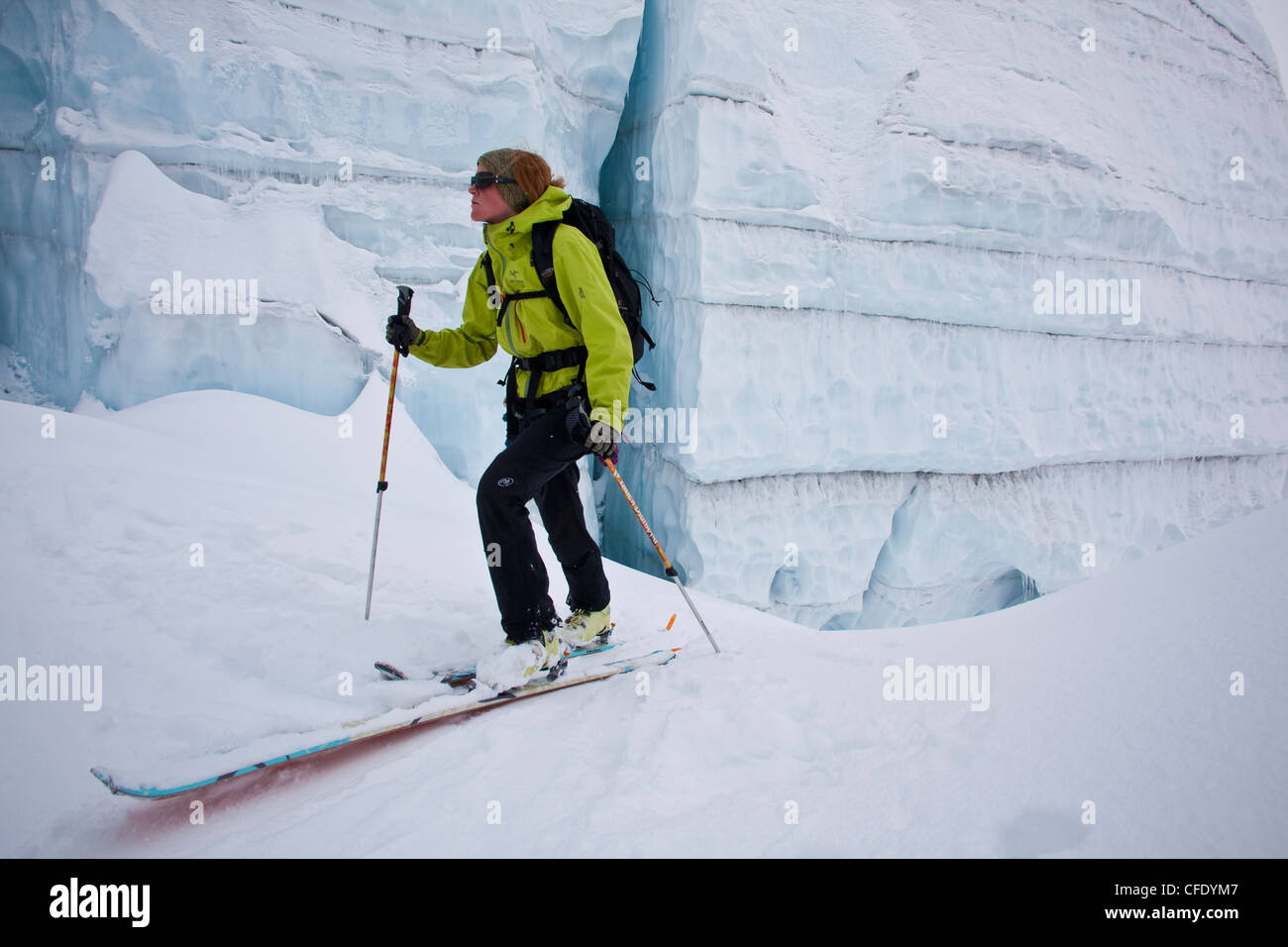 A woman backcountry ski touring through incredible glacier ice. Icefall Lodge, Golden, British Columbia, Canada Stock Photo