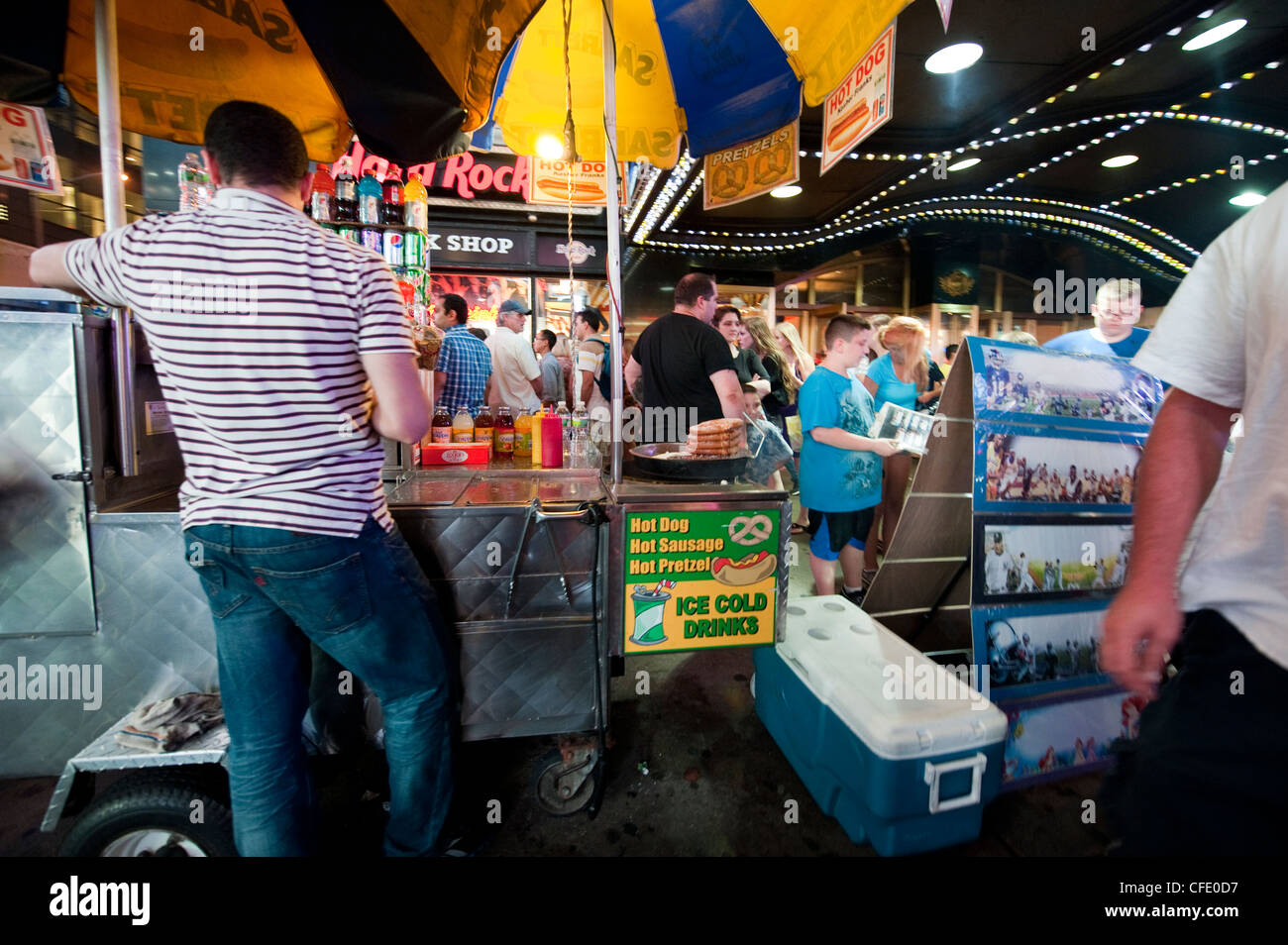 Bustling Times Square on a hot dog stand. New York, at night. USA. Stock Photo