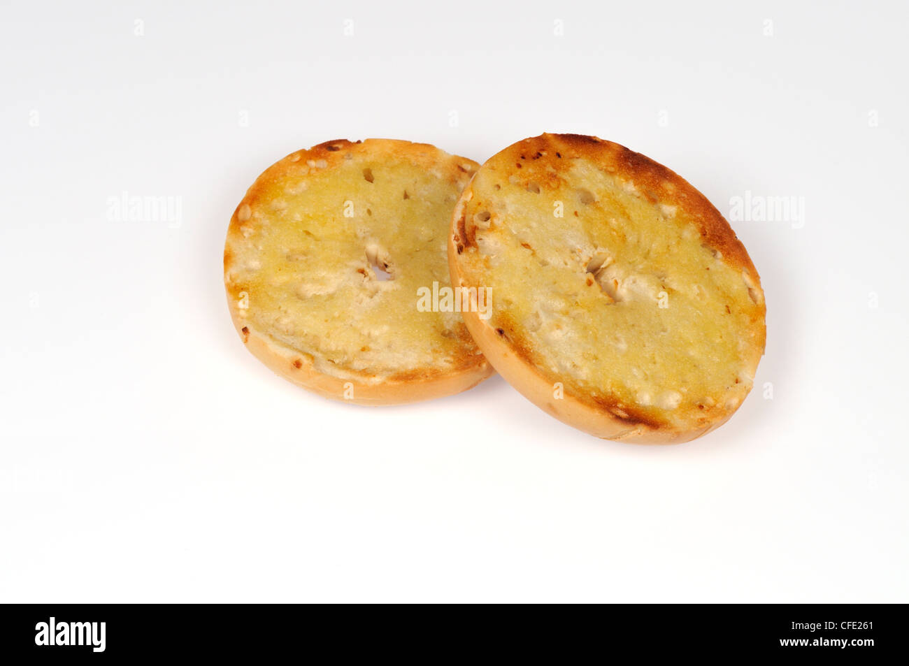 Toasted bagel with butter on white background Stock Photo