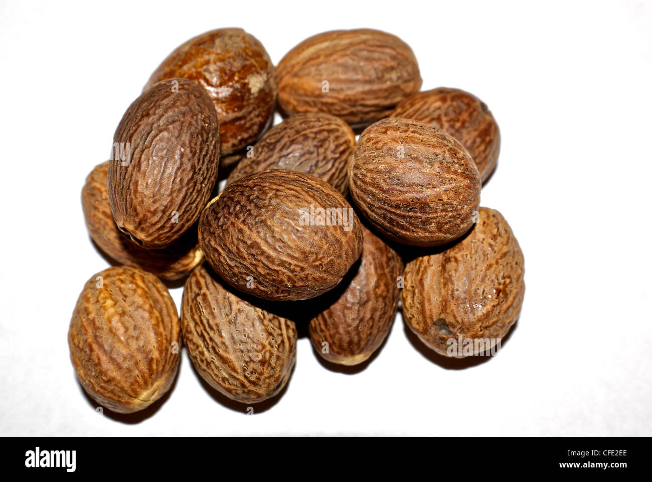 Whole dried nutmeg seed pods aromatic spice Myristica fragrans Stock