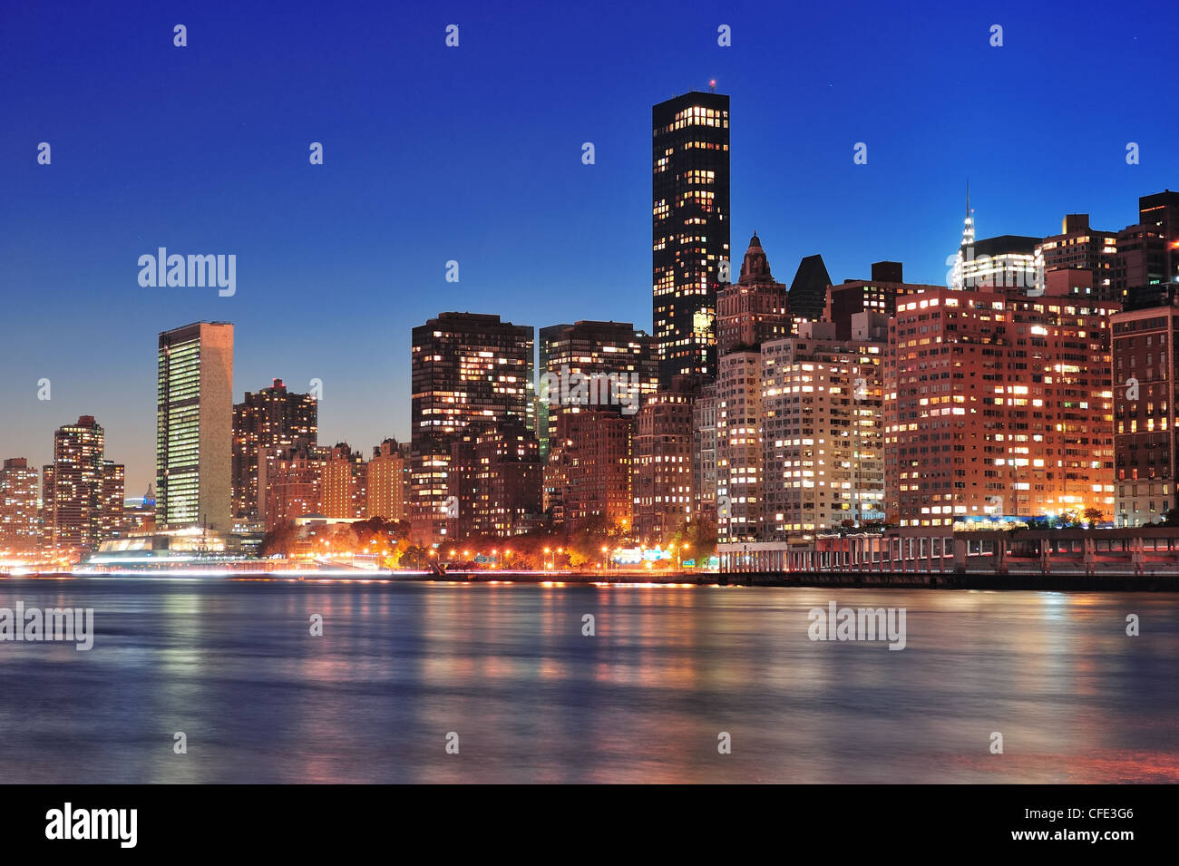 New York City Manhattan midtown skyline at night over East River Stock ...