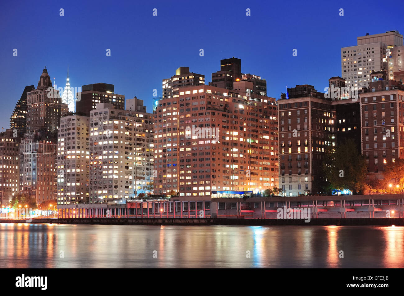 New York City Manhattan midtown skyline at night over East River Stock ...