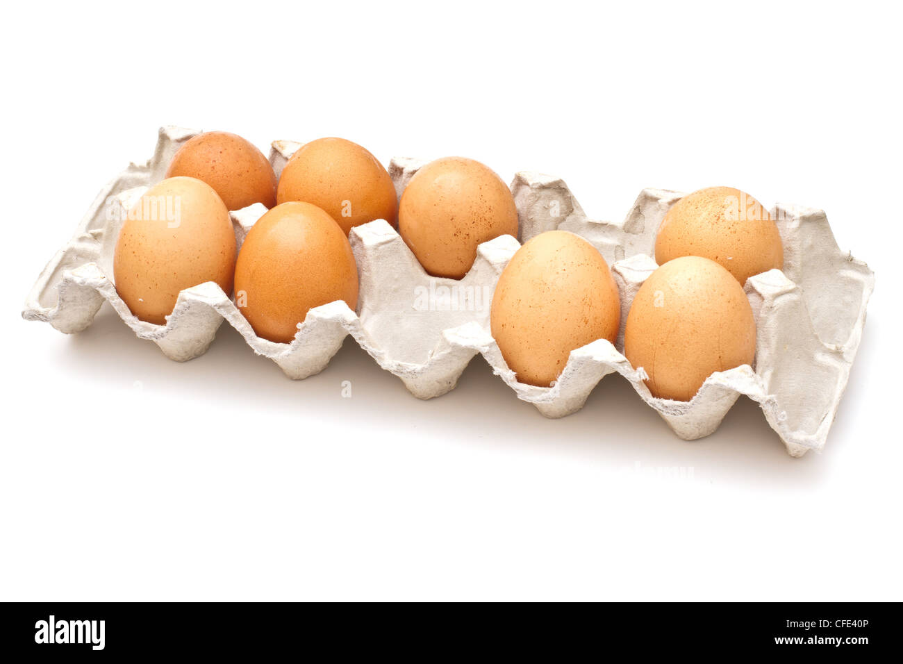 Brown eggs in a carton package on white background Stock Photo