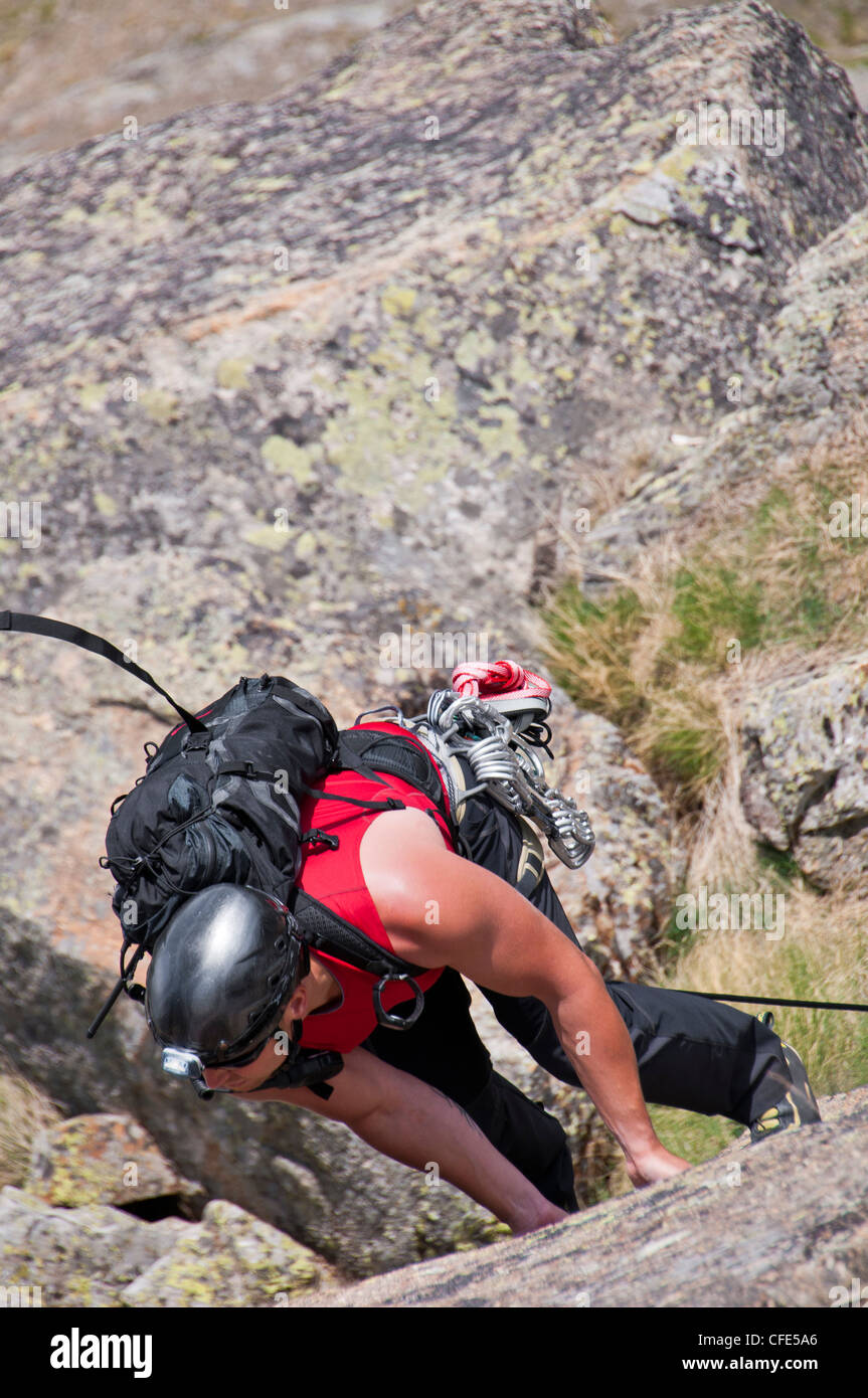 climber while climbing a vertical rock wall Stock Photo Alamy