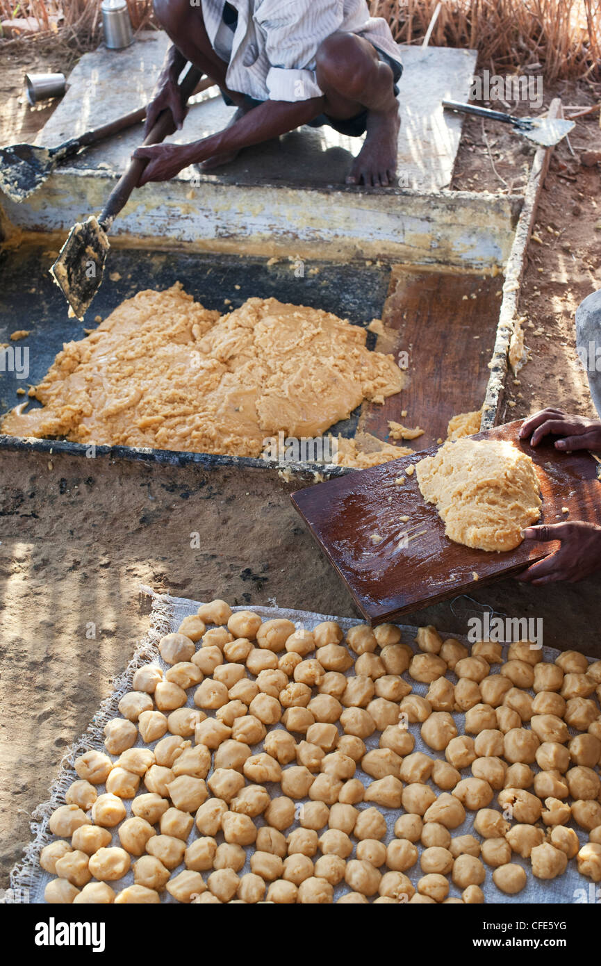 Jaggery production in the rural south Indian countryside. Rolling Raw unrefined sugar. Andhra Pradesh, India Stock Photo