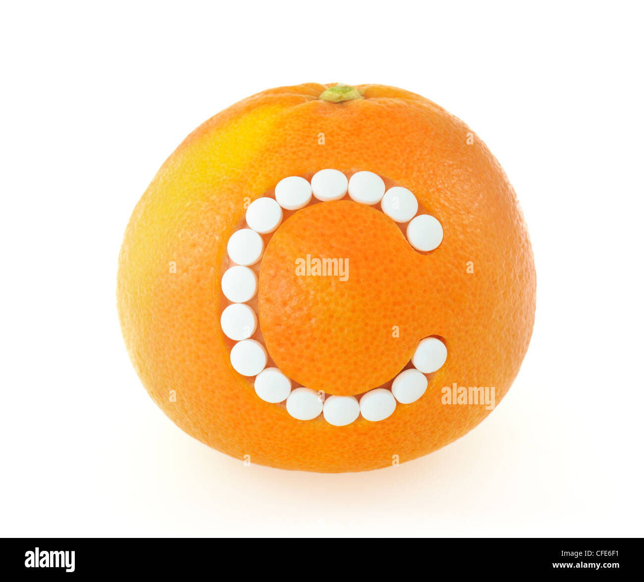 Grapefruit with vitamin c pills over white background - isolated - health concept Stock Photo