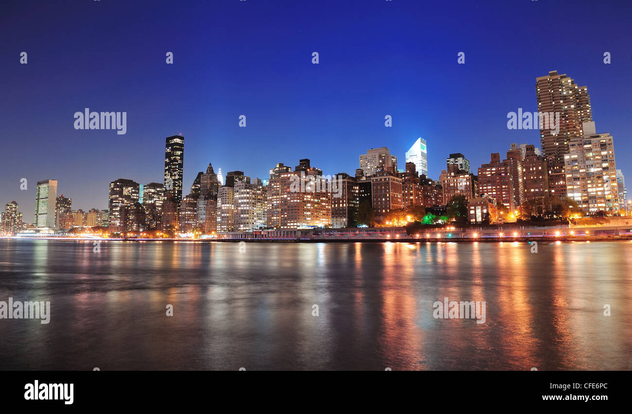 New York City Manhattan midtown skyline at night over East River Stock ...