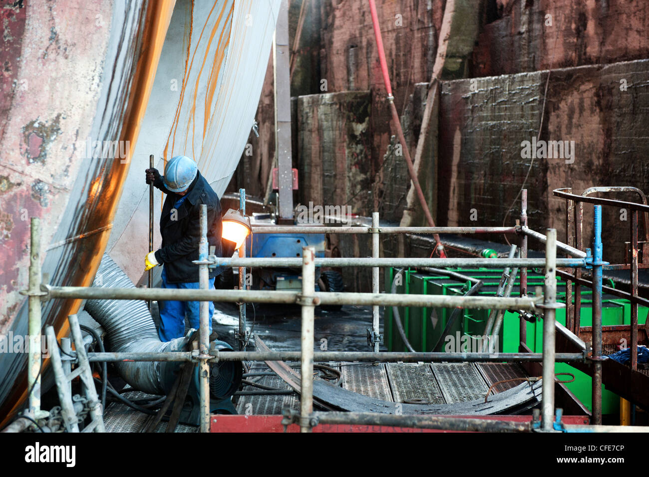 Reparation of the bow thrusters of an industrial supply vessel in a dry dock Stock Photo