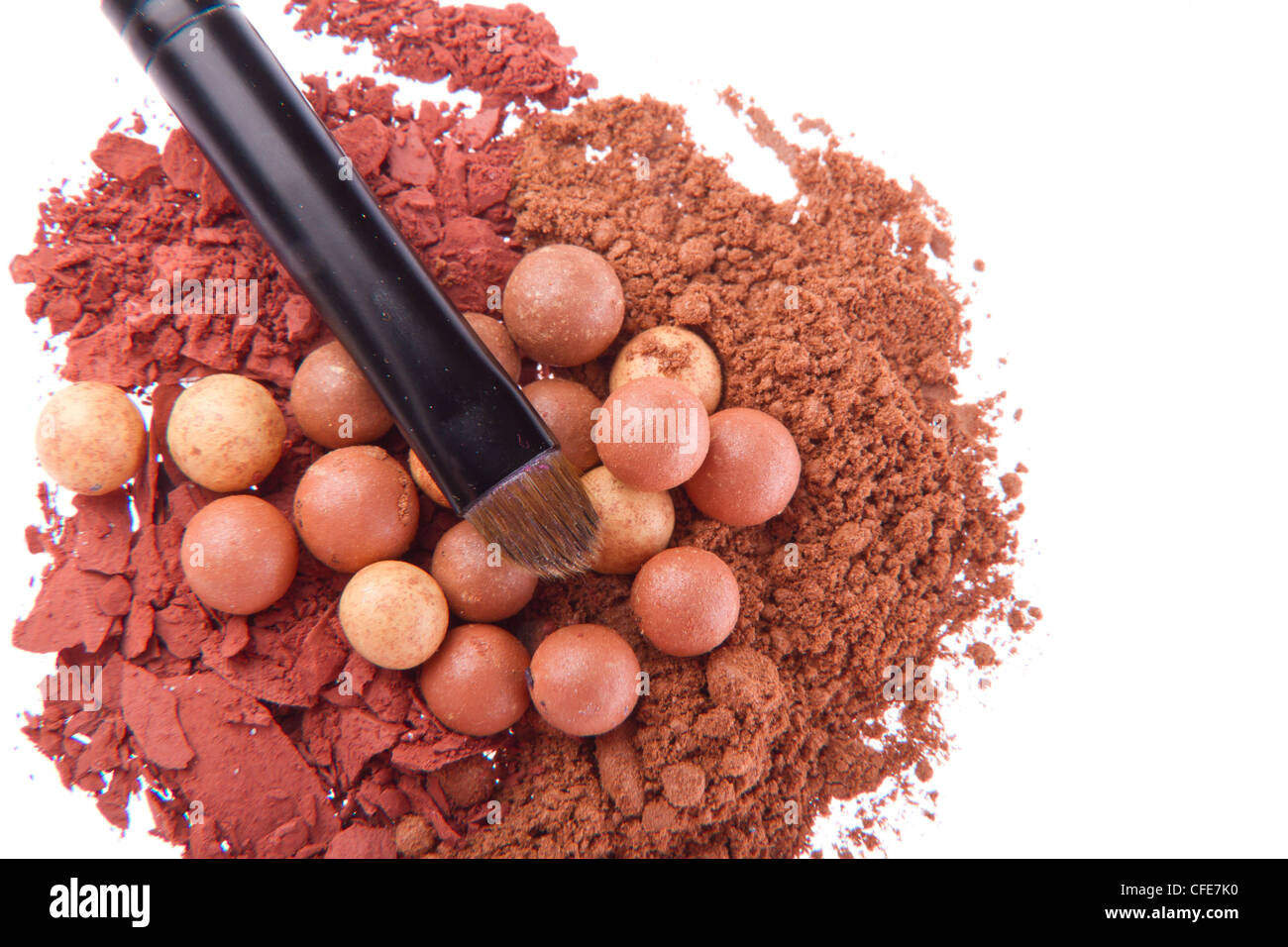 bronzing pearls and crushed eyeshadows with brush isolated on white