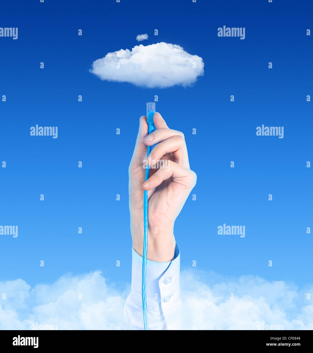 Hand with the cable connected to the cloud. Conceptual image on cloud computing theme. Stock Photo
