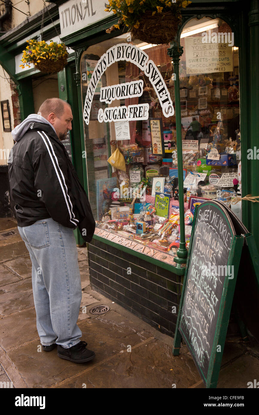 UK, England, Yorkshire, Thirsk, Market Place, man looking in traditional sweet shop window Stock Photo