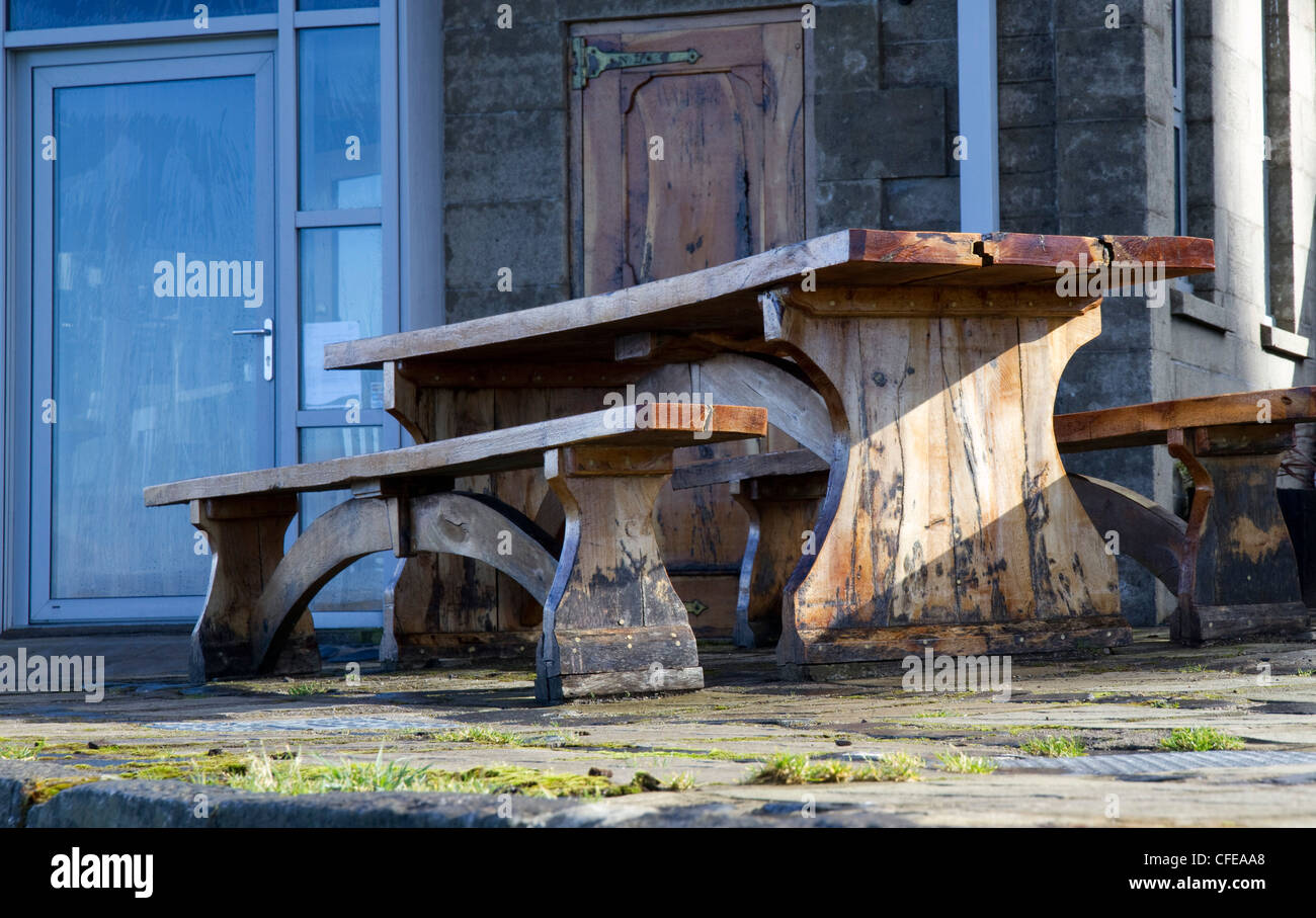 A wooden table and benches outside the Seafood Temple restaurant in Oban, west Scotland Stock Photo