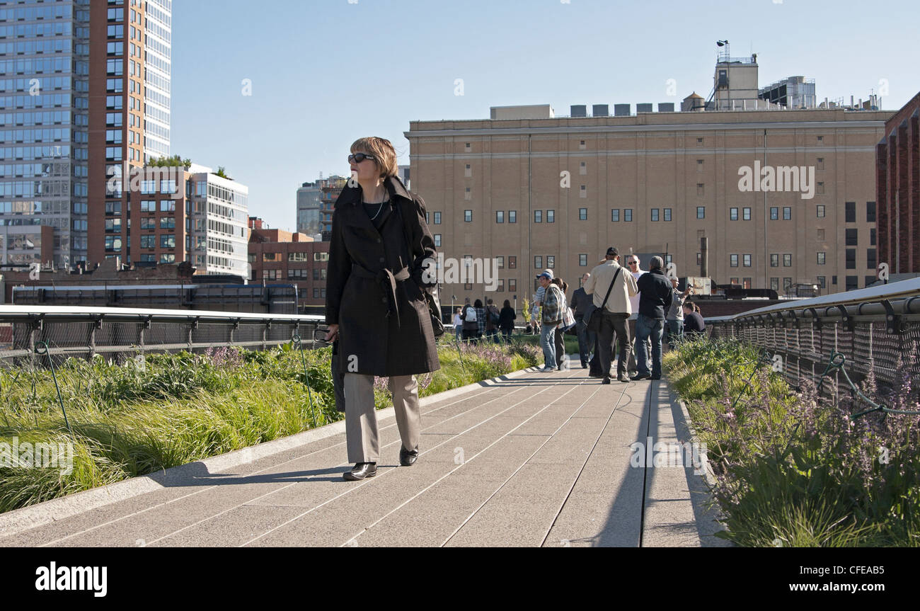 A woman walks along a path on The High Line in New York City Stock ...