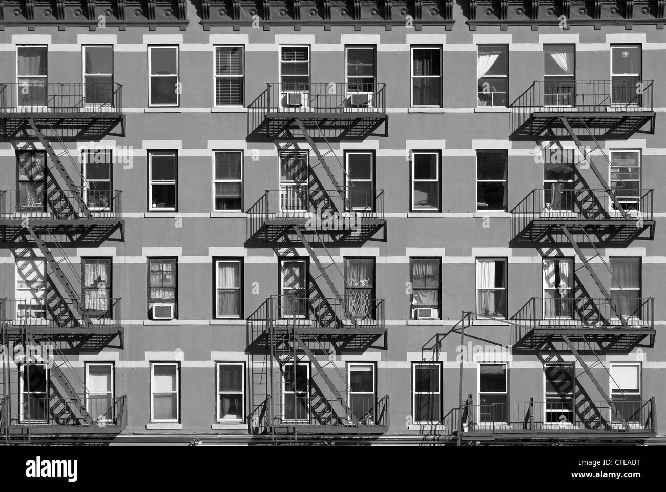 An apartment building in New York City takes on a geometric pattern in the afternoon sun. Stock Photo
