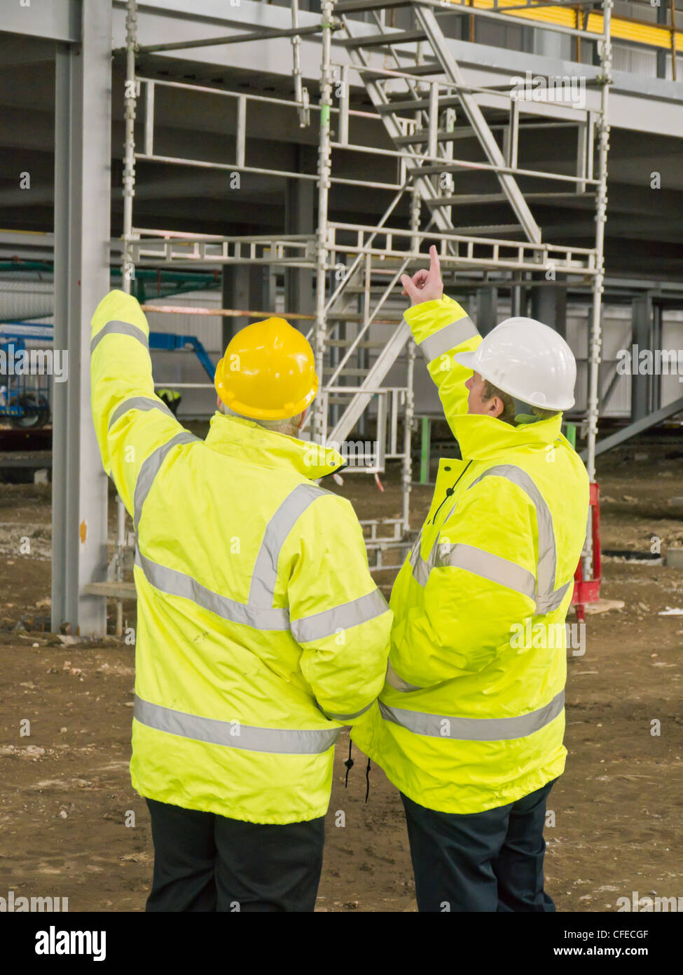 Two supervisors on a construction site pointing Stock Photo