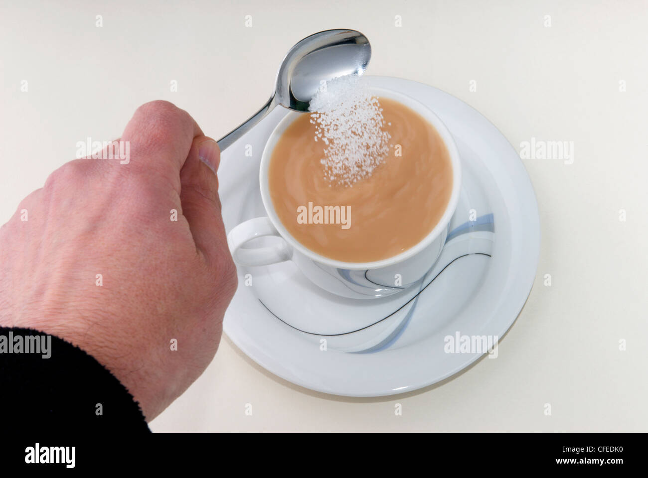 Time for tea.  A nice cup of tea ready and waiting to refresh it just needs a bit of sugar to sweeten. Stock Photo