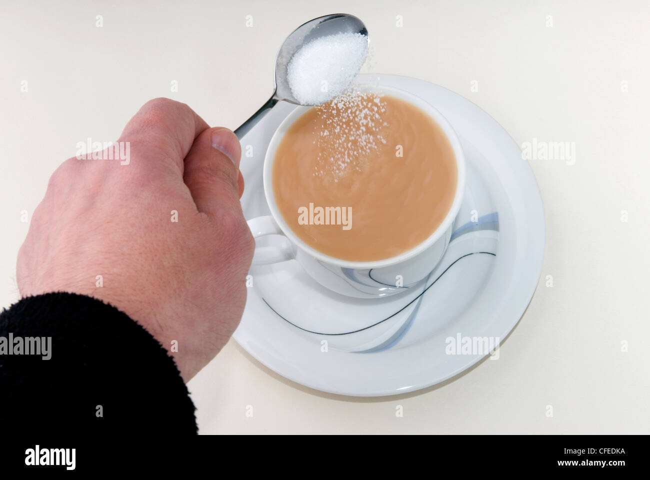 Time for tea.  A nice cup of tea ready and waiting to refresh it just needs a bit of sugar to sweeten. Stock Photo