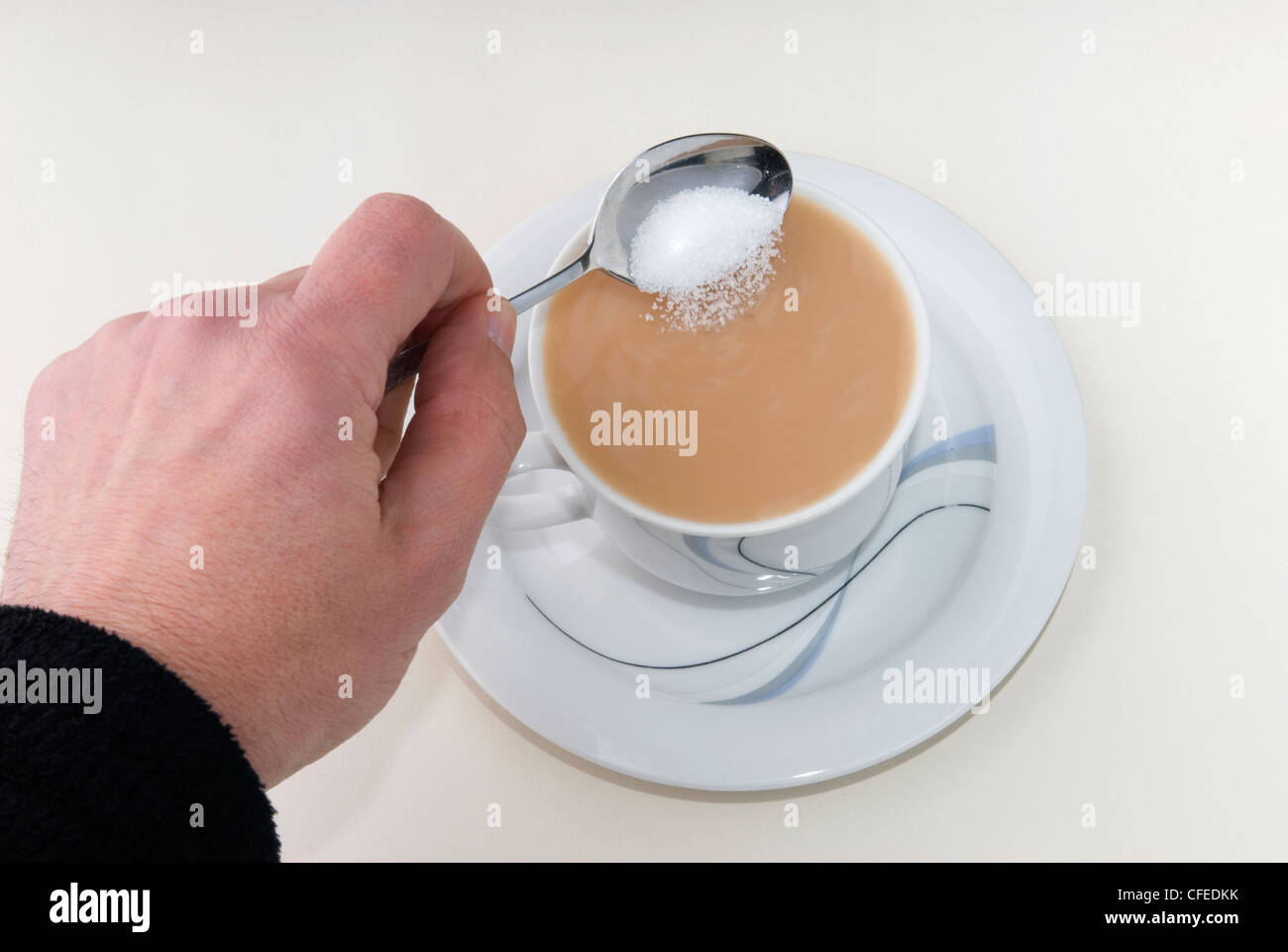 Time for tea.  A nice cup of tea ready and waiting to refresh it just needs a bit of sugar to sweeten. Stock Photo