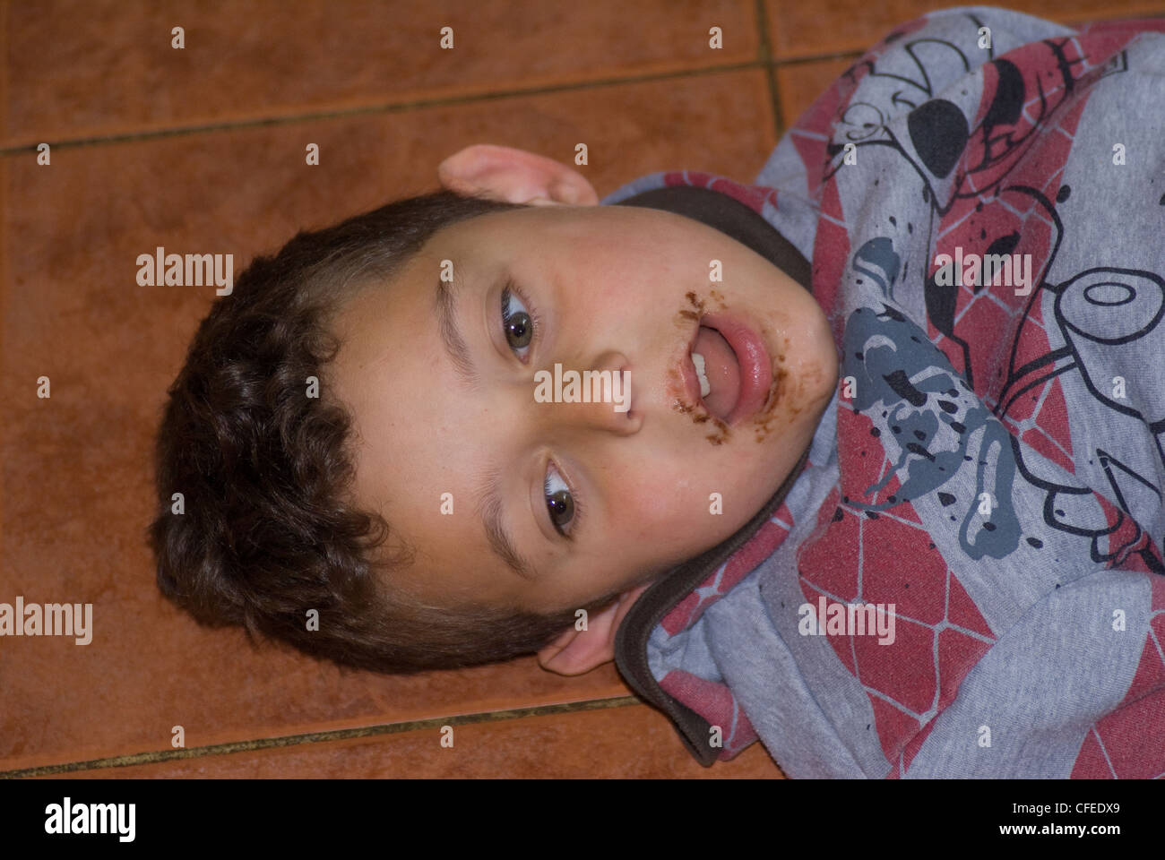 Young boy with mouth covered in chocolate Stock Photo