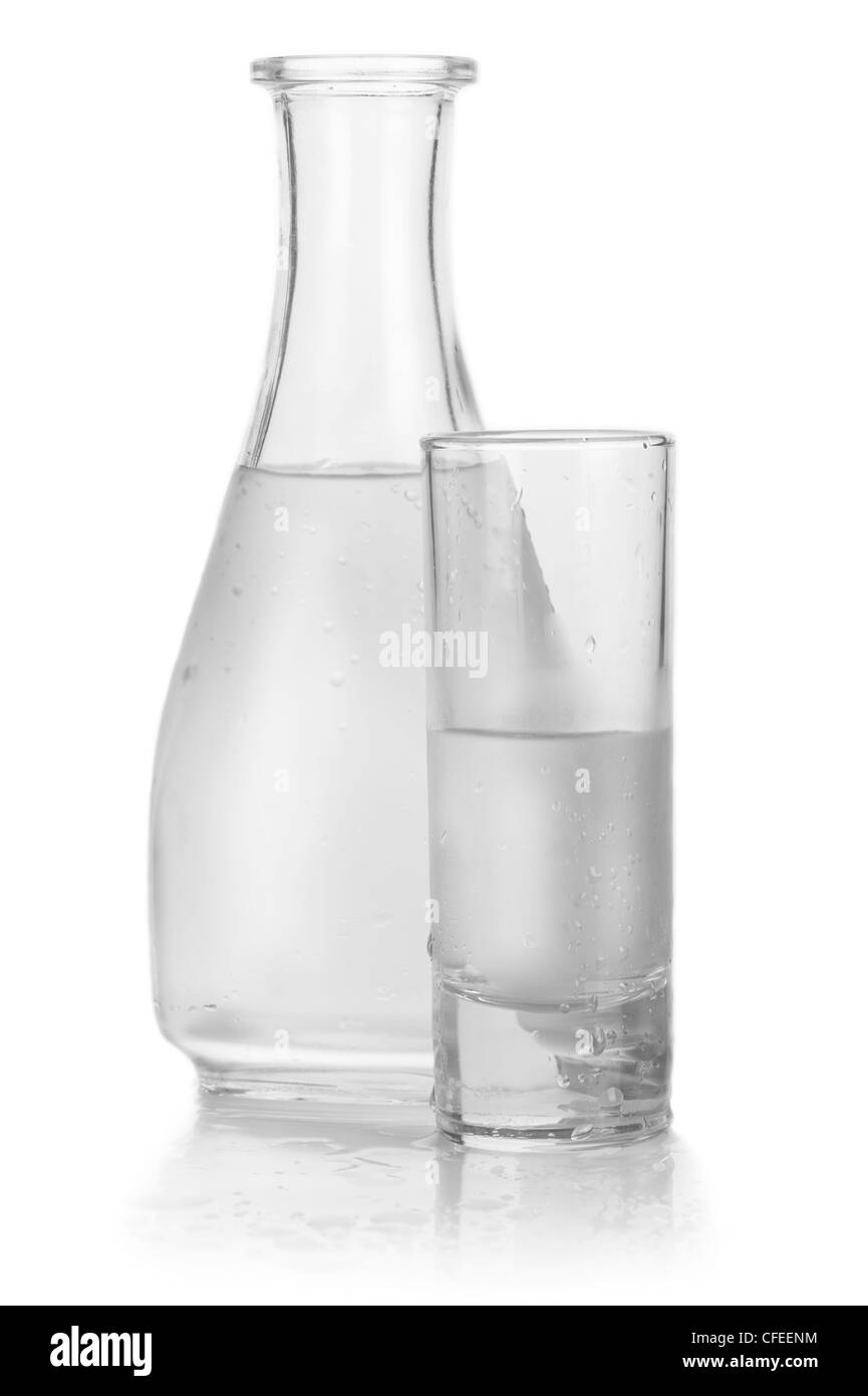 Decanter and glass of iced vodka with drops on white background Stock Photo