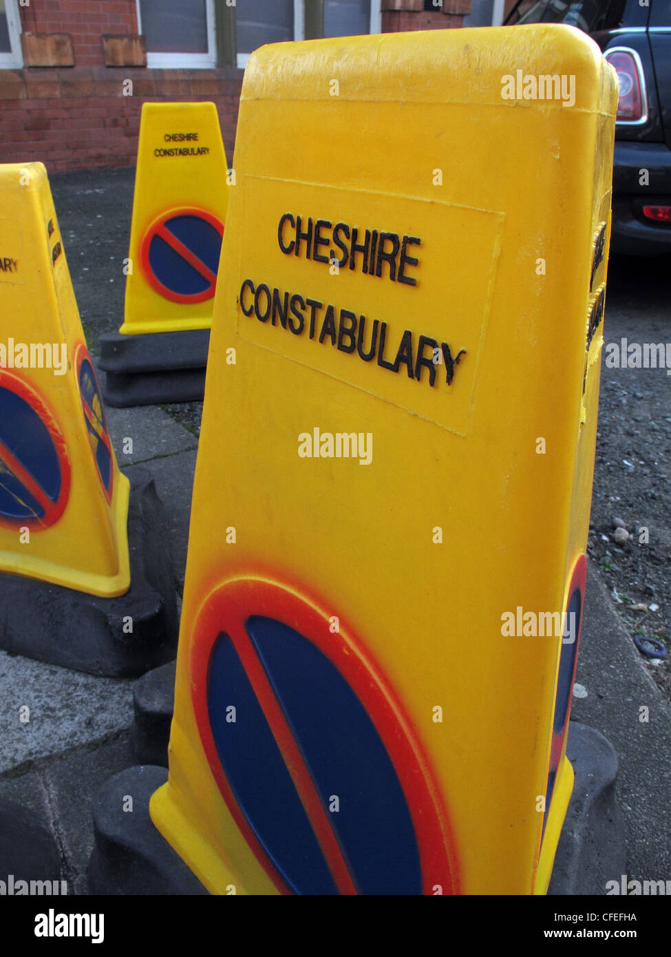 Yellow Cheshire Constabulary incident cones in road Stock Photo