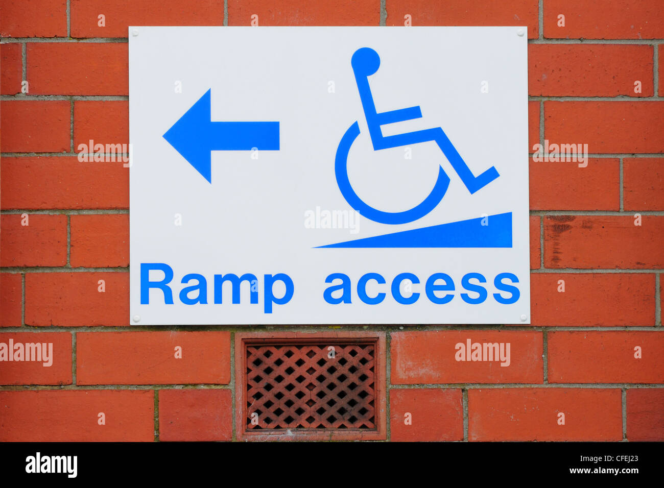 Sign for wheelchair users showing direction to ramp access Stock Photo