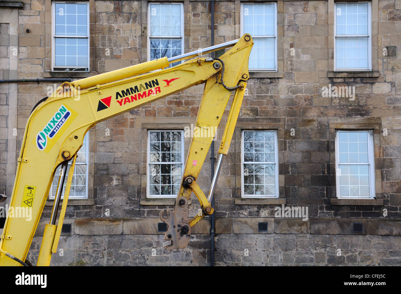 A small hydraulic arm and a series of sliding sash windows. Stock Photo