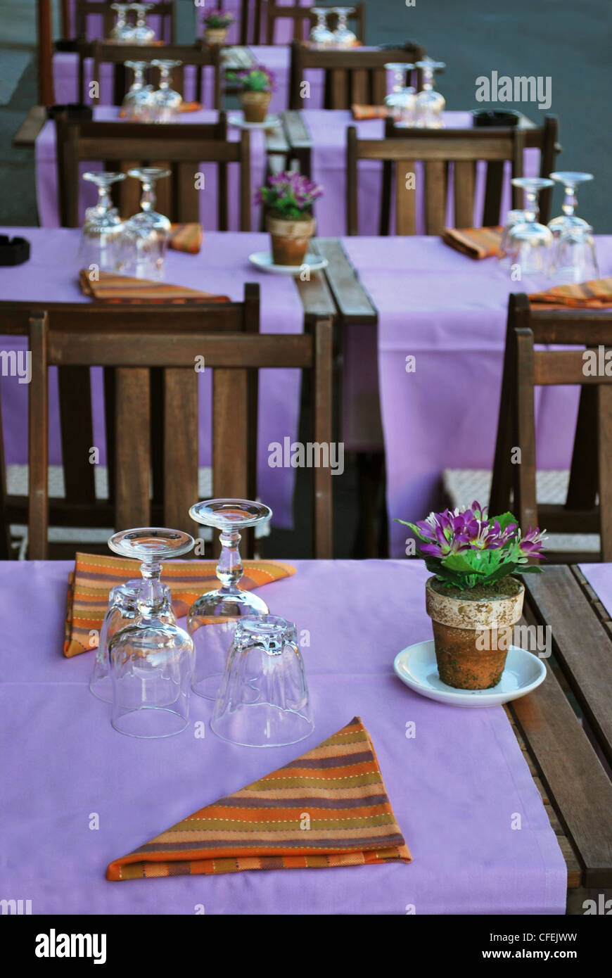 Violet and orange table setting in outdoor restaurant Stock Photo