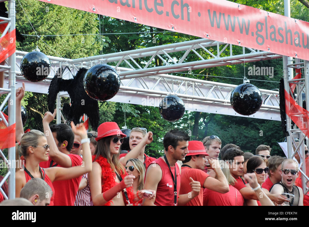 People wearing red clothes dancing during the Street Parade 2011 in Zurich. Stock Photo