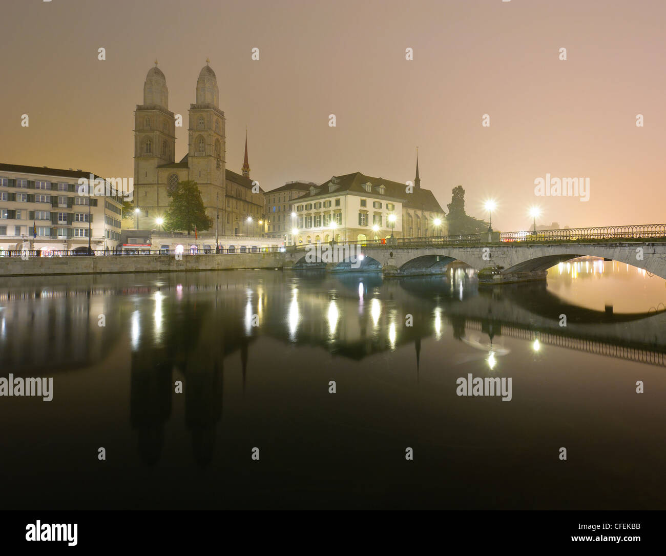 View of Zurich and old city center reflecting in the river Limmat at night. Stock Photo