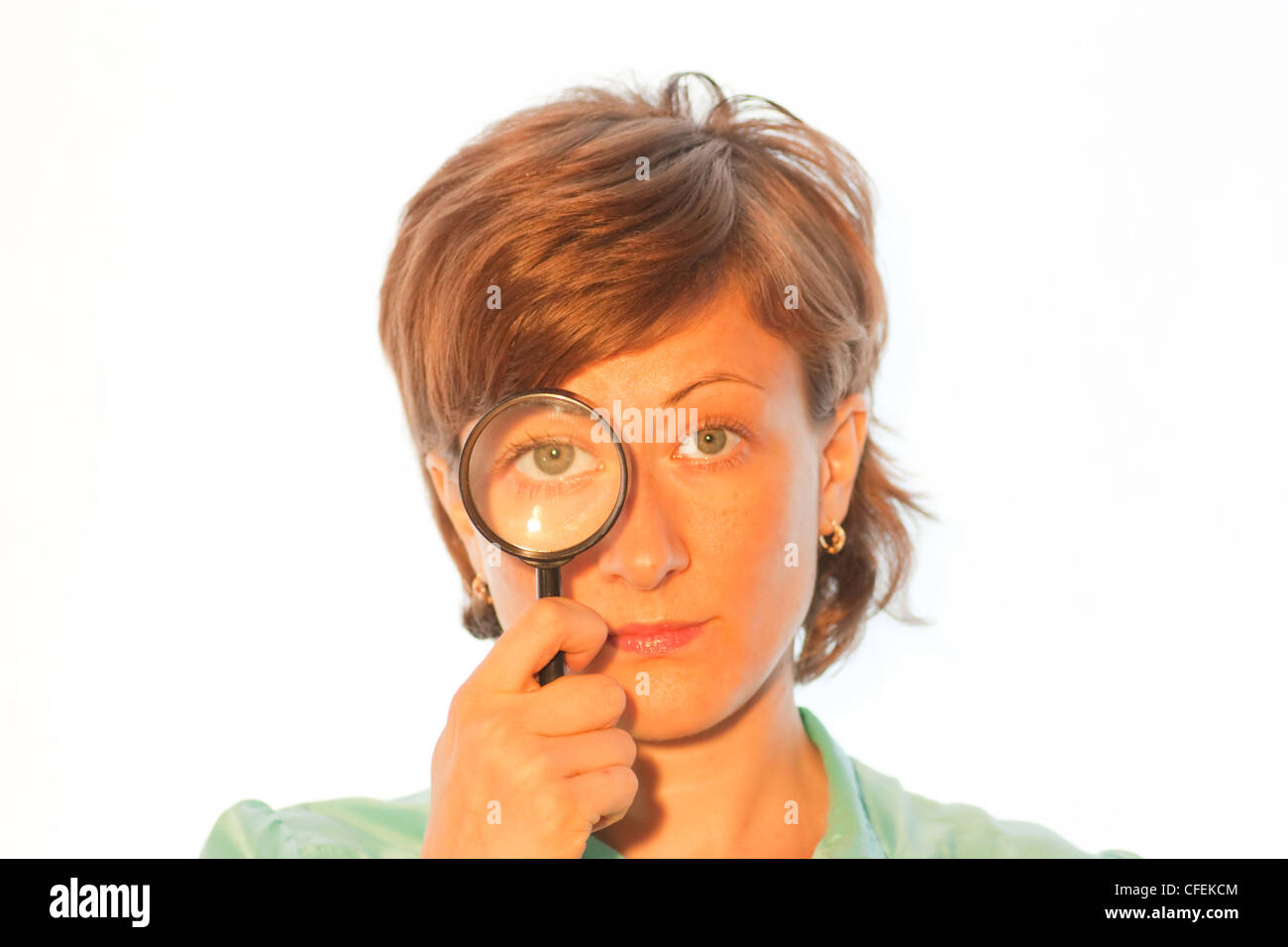 Woman with magnifier lens on eye Stock Photo