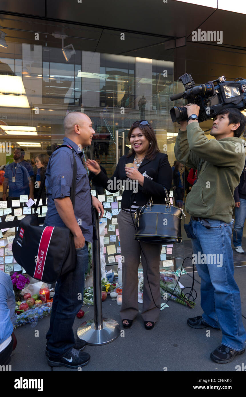 A news crew shooting an interview on the day of Steve Jobs death outside the Apple Store San Francisco Stock Photo