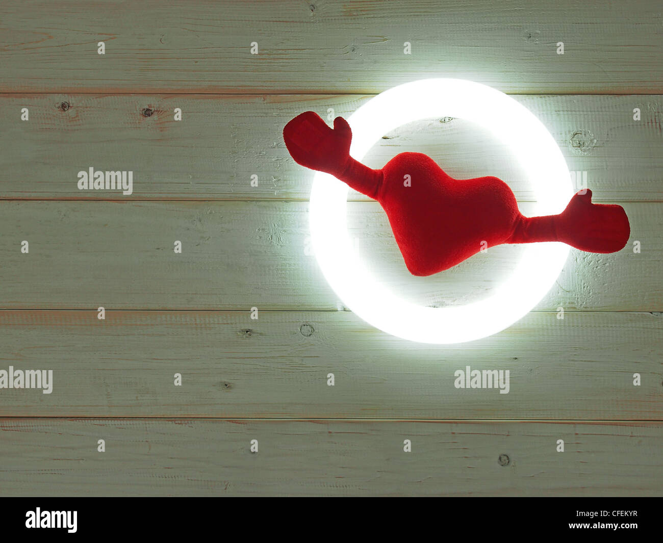 One soft heart with two hands in the ring light. Stock Photo