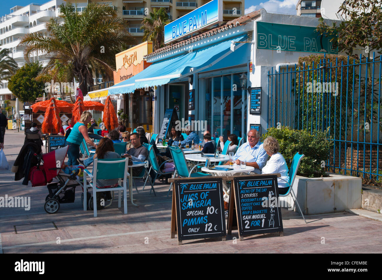 Cafe bar terrace along Paseo Maritimo seaside promenade Marbella Andalusia Spain Europe Stock Photo