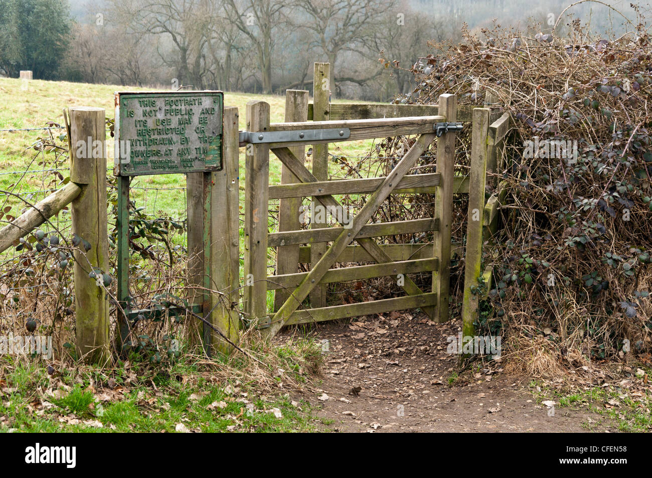 No public right of way sign beside a wooden kissing gate an entrance to a field in Jordans Bucks UK Stock Photo