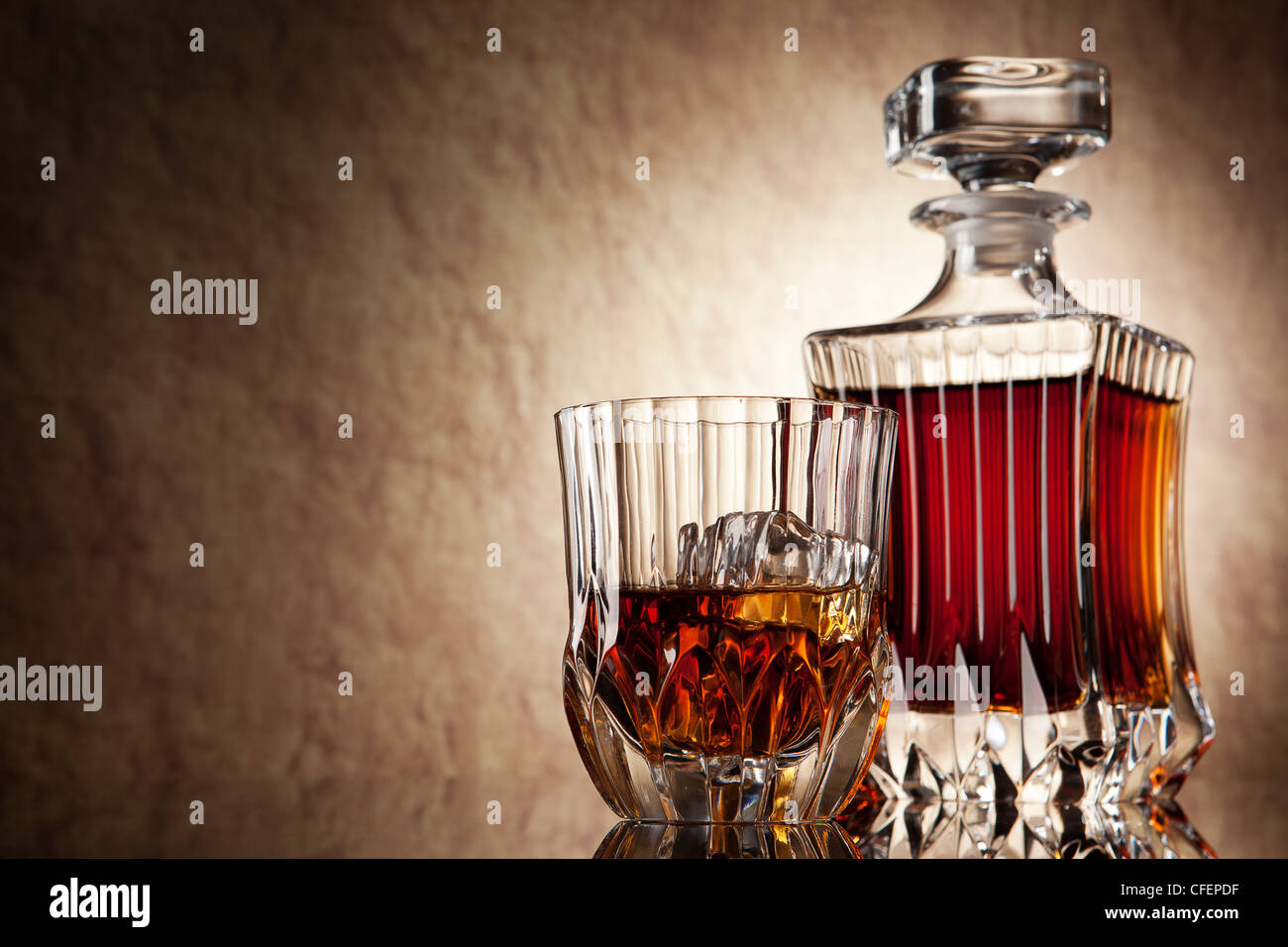 glass and decanter of brandy on a old stone background Stock Photo Alamy
