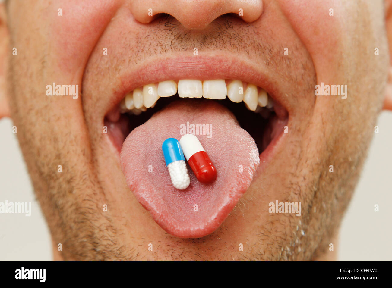 Medicine pills are administered by mouth, posed image Stock Photo