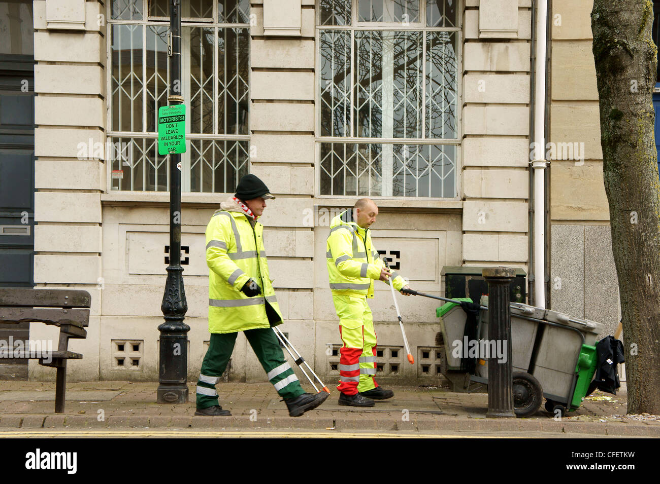 Street Cleaners collecting litter in Cardiff Bay, South Wales, UK Stock