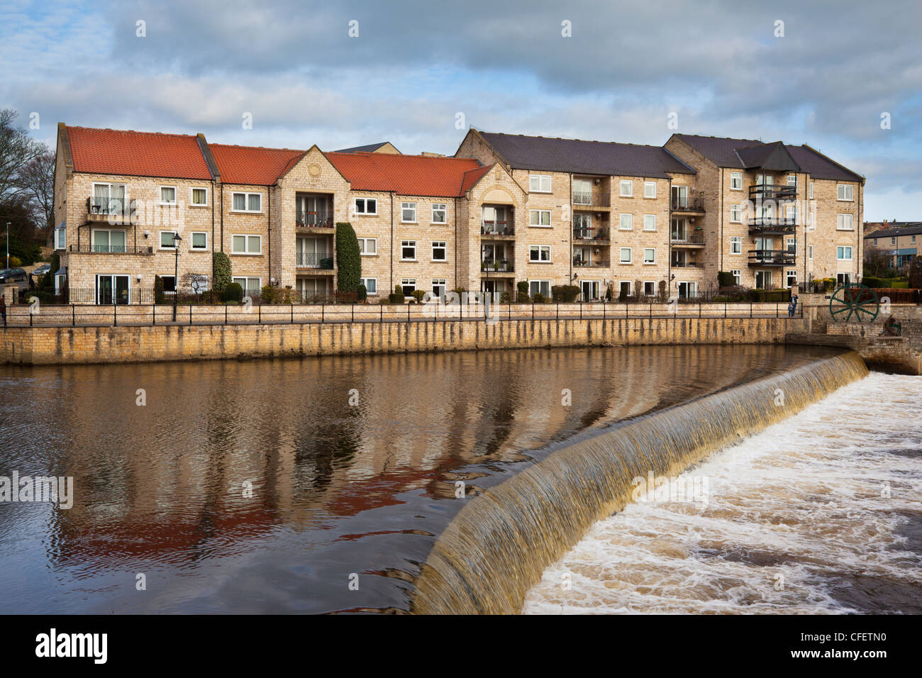 Modern apartment buildings beside The River Wharfe at Wetherby weir, Wetherby, West Yorkshire, UK Stock Photo