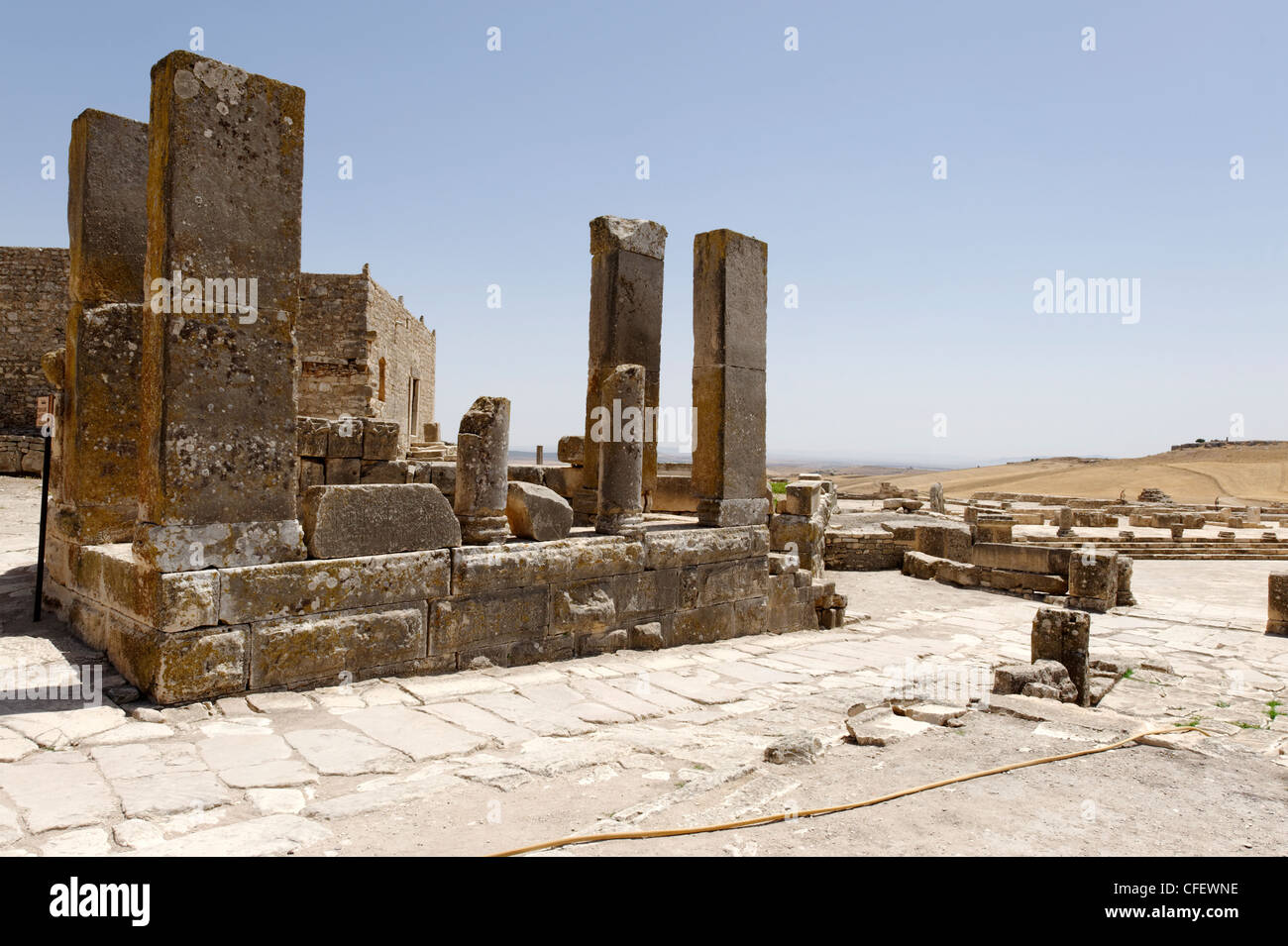 Dougga. Tunisia. View of the small 2nd century Temple of Augustine Piety beside the Square of the winds. Dougga is wonderfully Stock Photo