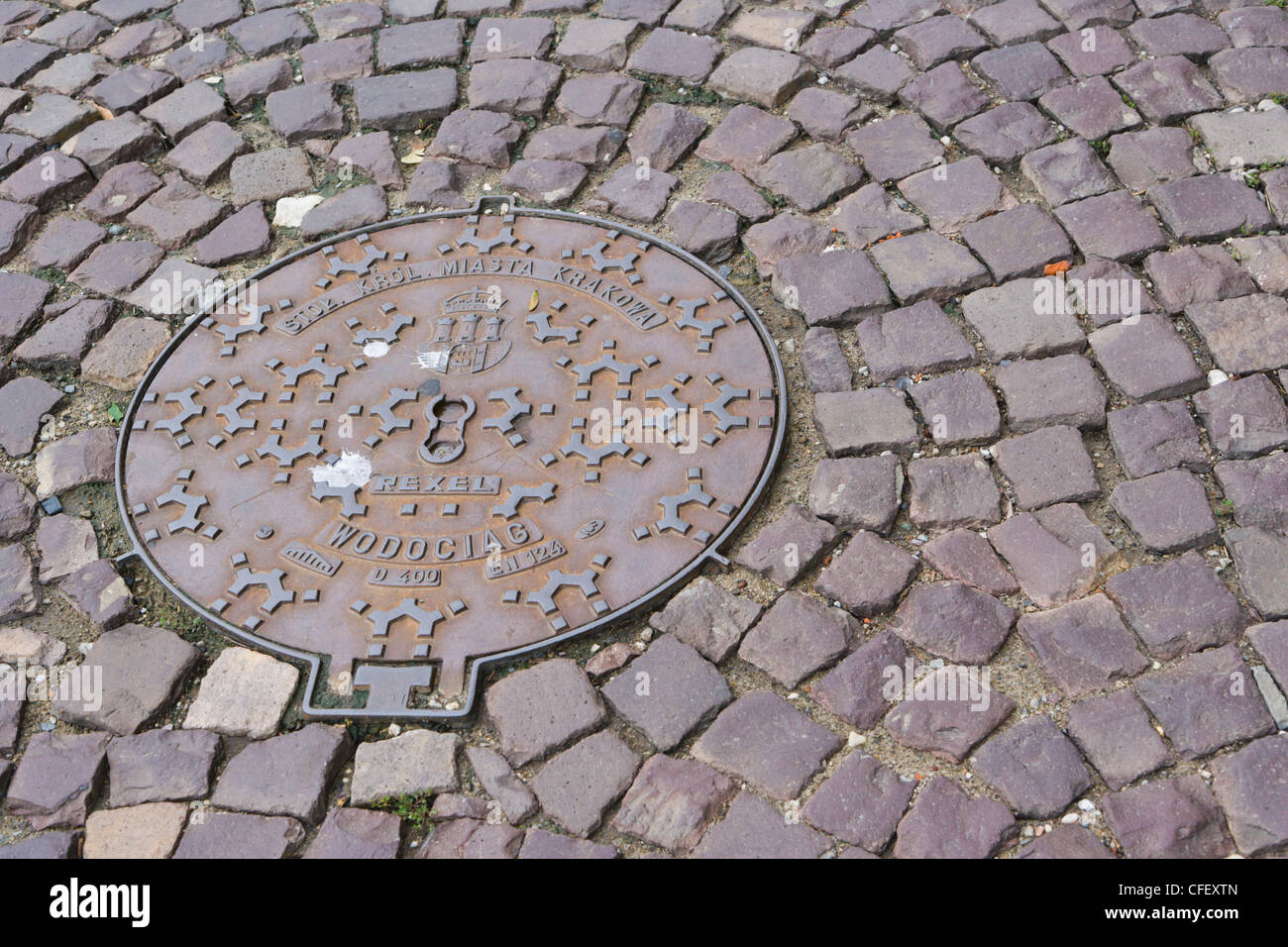Sewer manhole on cobbled street, Old Town, Krakow, Cracow, Malopolska Province, Lesser Poland Voivodeship, Poland Stock Photo