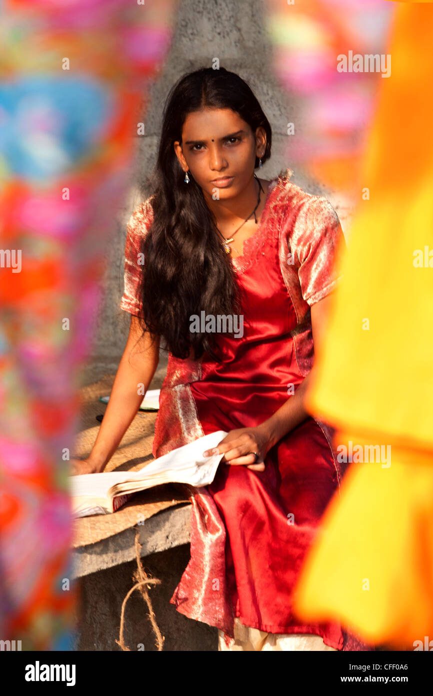 Student girl, sitting behind bright coloured silks, Kerala, India, Asia  Stock Photo - Alamy
