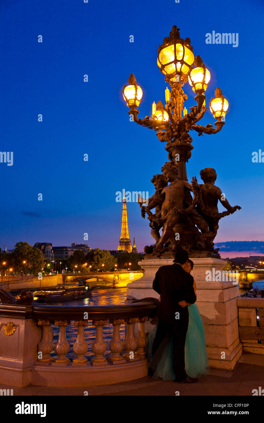 Eiffel Tower seen from the Pont Alexandre III (Alexander III Bridge) at night, Paris, France, Europe Stock Photo