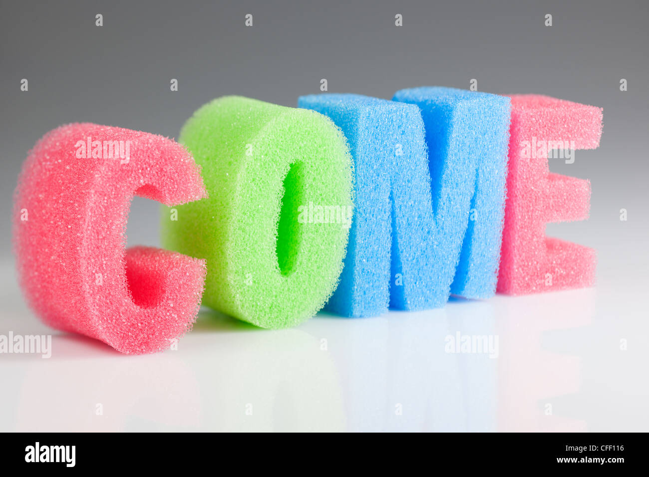 Come spelled out in coloured sponge letters Stock Photo