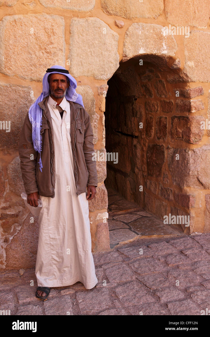 The gate keeper stands by the entrance to the UNESCO World Heritage Site of St. Catherine's Monastery, Sinai Peninsula, Egypt Stock Photo