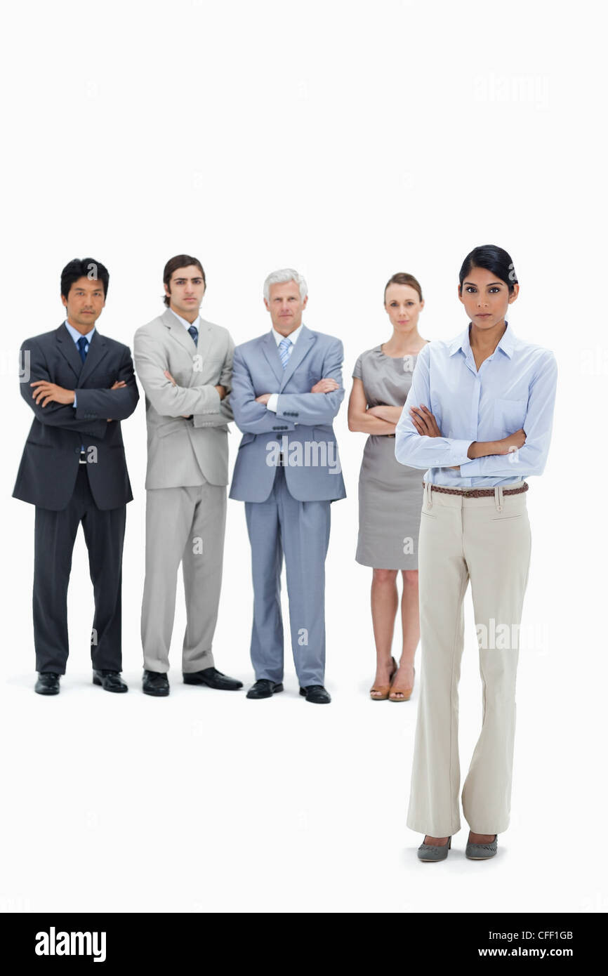 Serious multicultural business team with their arms folded with a woman in foreground Stock Photo