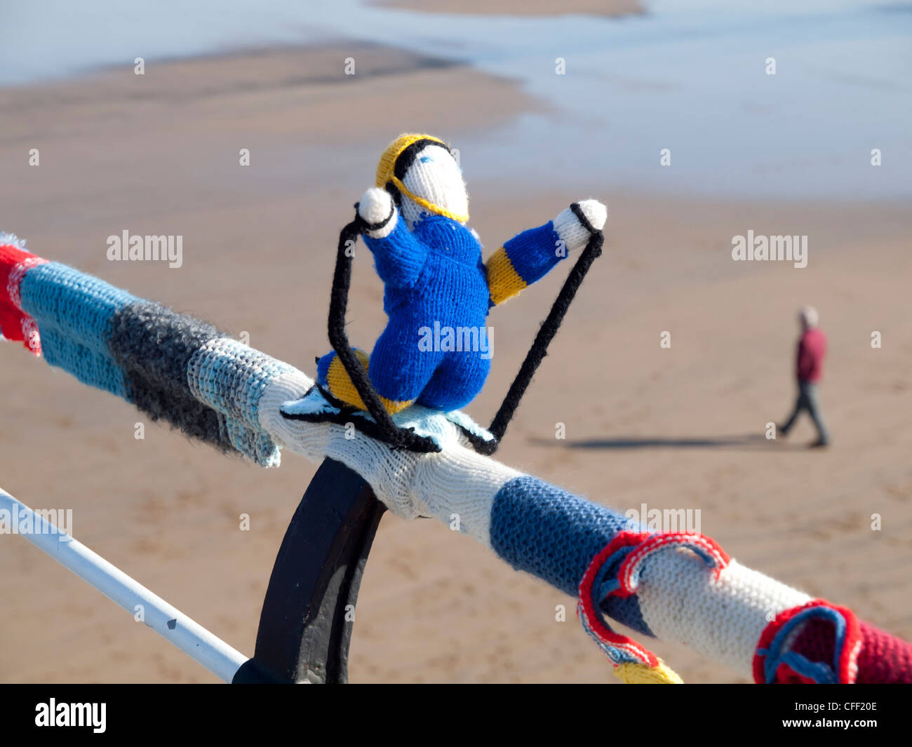 Yarn Bombing decorating public places with knitted objects here Olympic  an Olympic skier on the Saltburn pier handrail Stock Photo